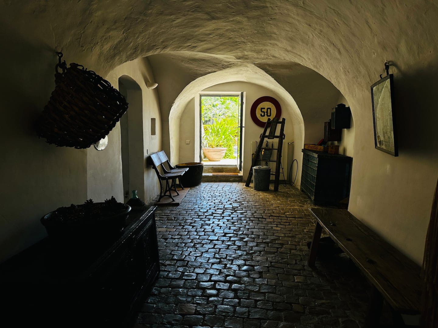 La ruelle pavée voûtée qui traverse le rez-de-chaussée, ouverte sur le jardin