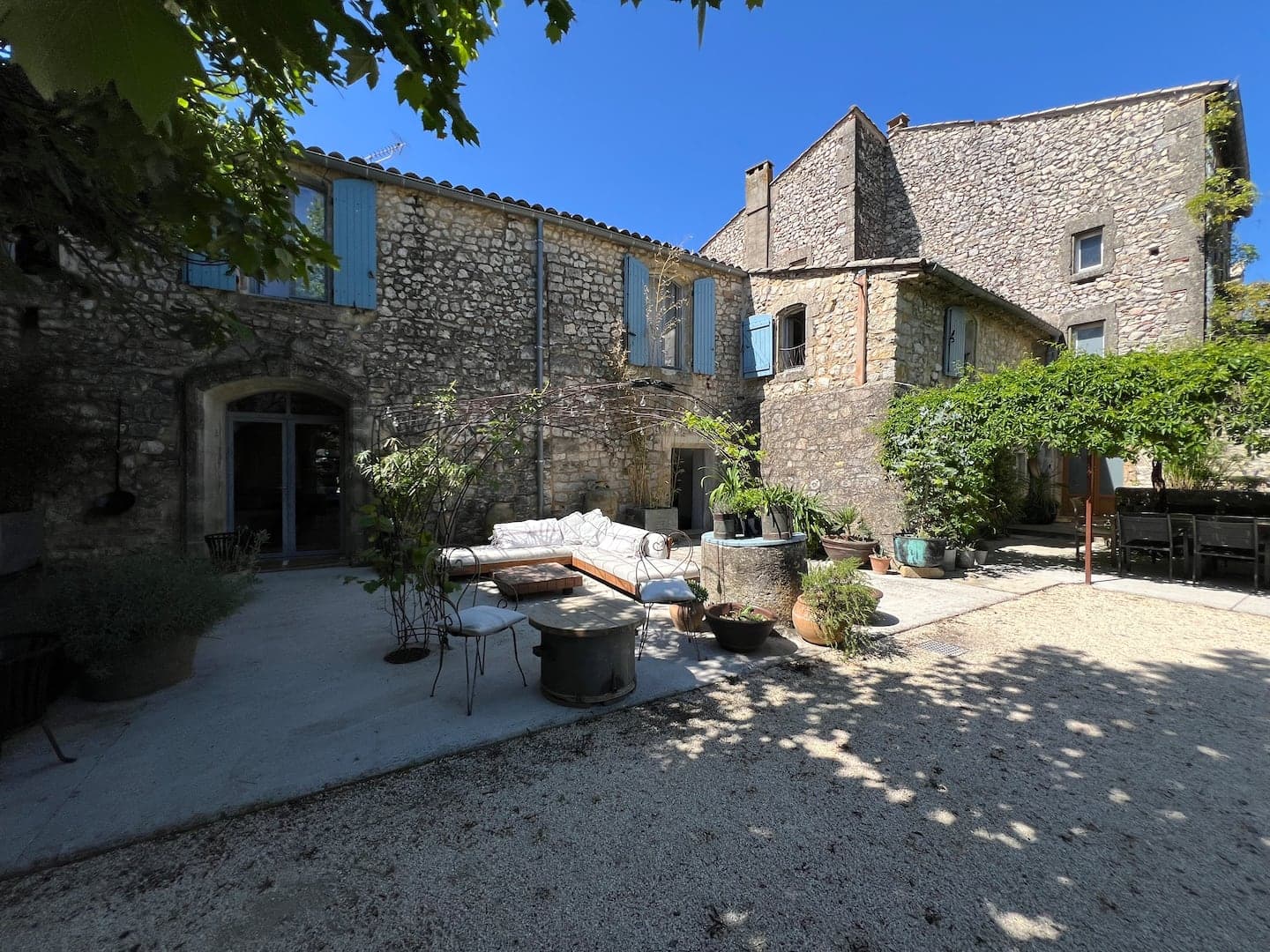 La cour gravillonnée et la façade en pierre